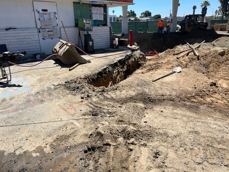 Excavation work with equipment and site tools near a building